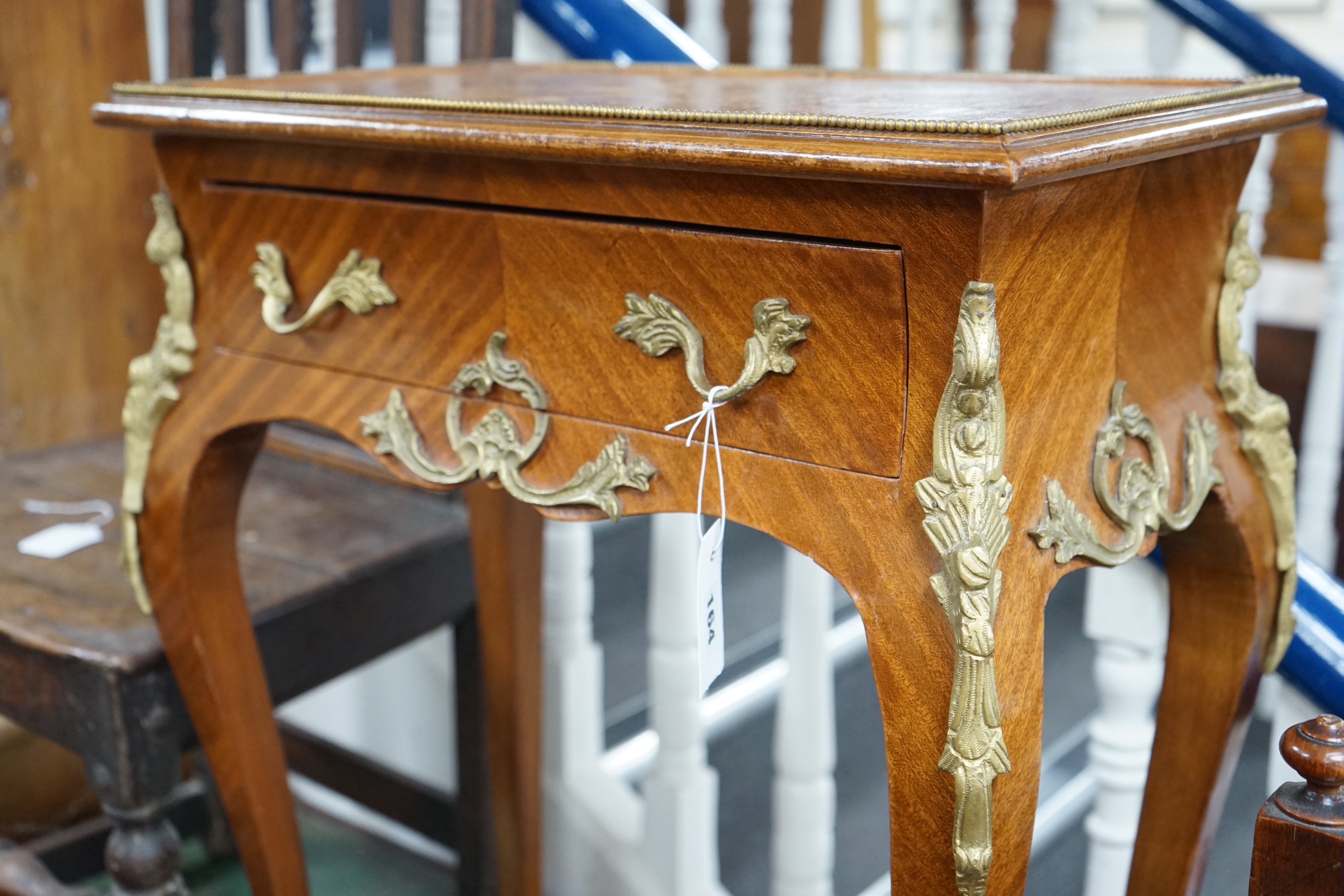 A Louis XVI style gilt metal mounted side table, width 56cm, depth 33cm, height 76cm